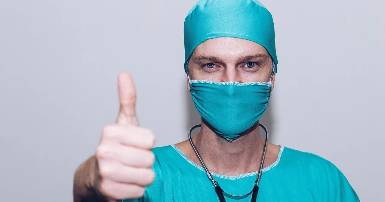 healthcare worker giving a thumbs up because they are appreciated on labor day